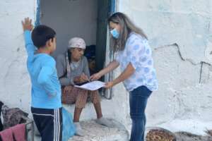 Aleksi and grandmother receiving NG aid parcels