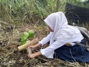 Having a go at planting trees.