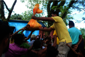 Volunteers Distributing Relief among Flood Victims