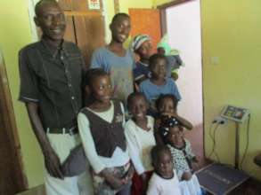 Tiko night watchman with his wife, (grand)children