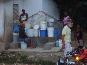 villagers line up for what little water there is