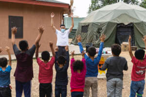 Migrant children dance at a Texas transit shelter