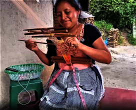 Albertina weaving a band for a sun hat.