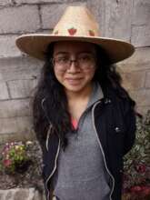 Jennifer modeling a hat she helped make