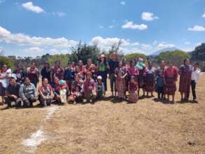 Us visiting a group, notice the volcano in back!