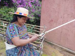 Ixoqi' weaver rocking a Sunshine Tienda hat