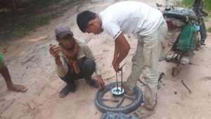 Stopping to fix a motorbike tire while on patrol.