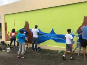 Community Members and Artist Painting Mural