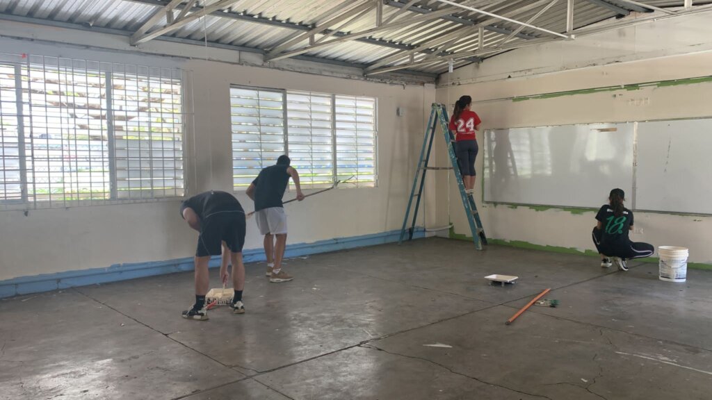 Volunteers painting the Moises School