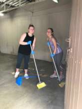 Volunteers sweeping in the Moises School