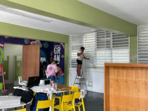 Young resident helping to clean the center