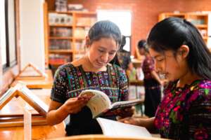 MAIA Girl Pioneers reading in the Library