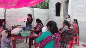 Marisol leading a workshop with community members.