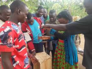 Women learn how to make bee hives in Labongo Masin