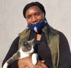 Kennel Manager Phile with a cat up for adoption