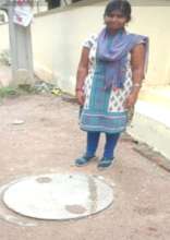 Student Stands at Completed Drainage System