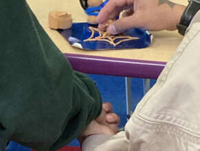 Participants hold hands during art therapy