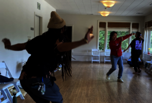 Workshop participants dance together