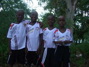 The four boys in their soccer uniforms