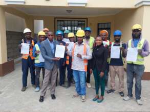 Board Chair with trainees at certificate ceremony