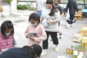 Our kids in Taitung helping sort food staples