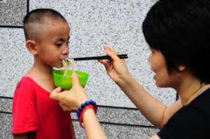 One of the younger children eating noodles