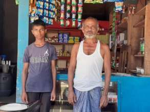 Pial with his father in front of their tea stall