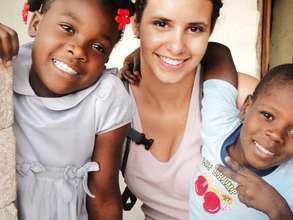Two orphans with their volunteer english teacher