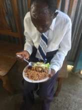 A man Eating at a Food Distribution after church!