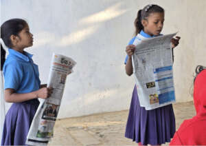 Reading newspapers aloud in morning assembly.