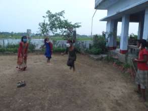 The girls enjoy skipping rope while at school.