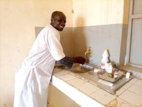 A health care worker accesses running water