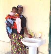 Mother and child at a sink in the clinic