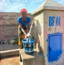 Young girl washing her hands in the courtyard
