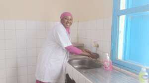 Midwife washing her hands in the delivery room