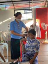 Receiving the "covid jab" from TLC staff.