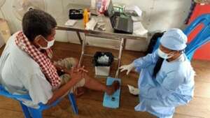 Doctor Sopeak treats the foot wounds of a diabetic