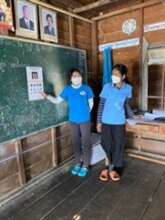 Two of TLC's Outreach Team test visual acuity.