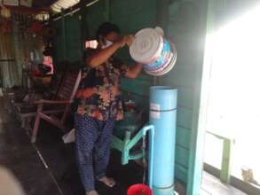 Installing a bio-sand filter in a floating home.