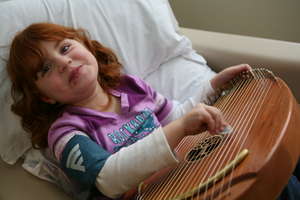 Little Girl Plays Instrument.
