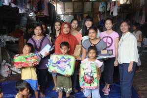Kids at the Jakarta landfill with school supplies