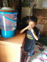Deden helps mom clean the water filter