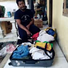Ewon Selecting Clothes for His Family