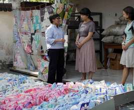 Retno shows Angela and Marissa waste materials.