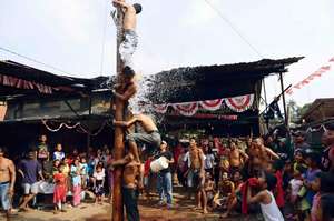 dowsed with water during panjat pinang challenge