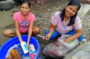 Supena and her sister, preparing trash to sell