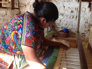 Lili weaving on her treadle foot loom