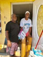 A family receiving relief supplies in Grand Bahama
