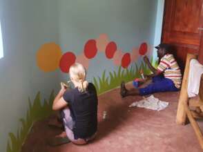 Volunteer painting the playroom.