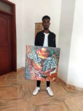 Daglous now 22 and his painting of the Gitar Man.